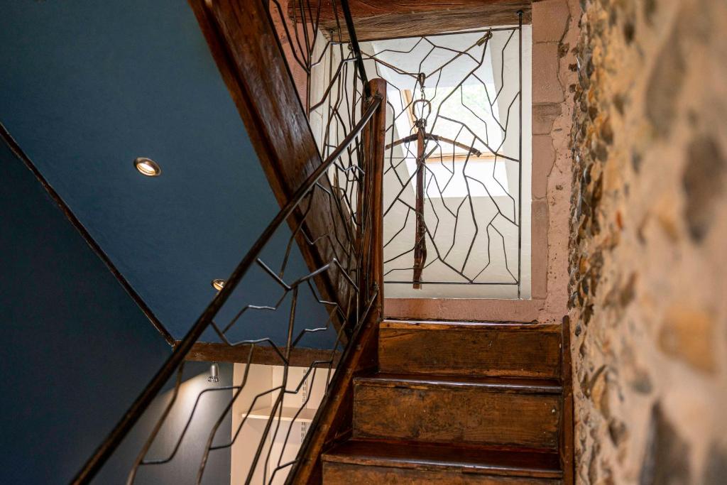 a staircase with a glass door in a house at Maison de charme à proximité de Pau - 3 chambres - 6 p - Jardin in Sendets