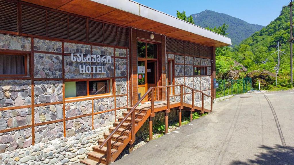 un edificio con una escalera fuera de él en Mtirala National Park hotel ORBEZA en Kobuleti