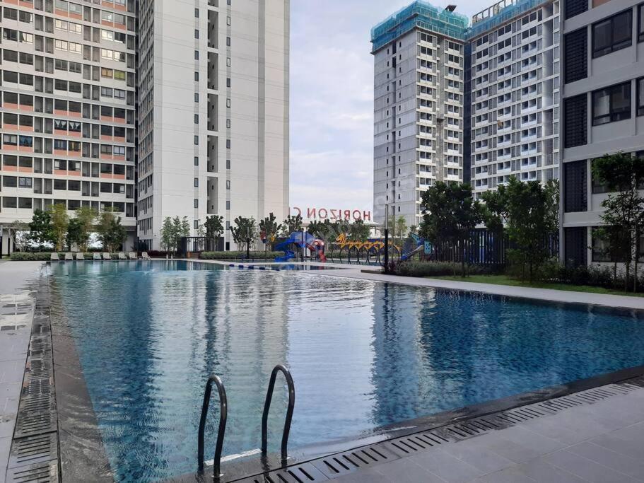 a large swimming pool in a city with tall buildings at DanZaStay1@HorizonSuite - nearby KLIA in Sepang