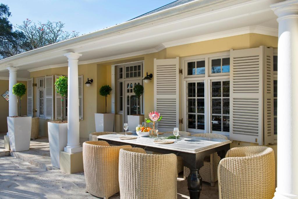 a patio with a table and chairs on a house at Auberge Daniella in Franschhoek