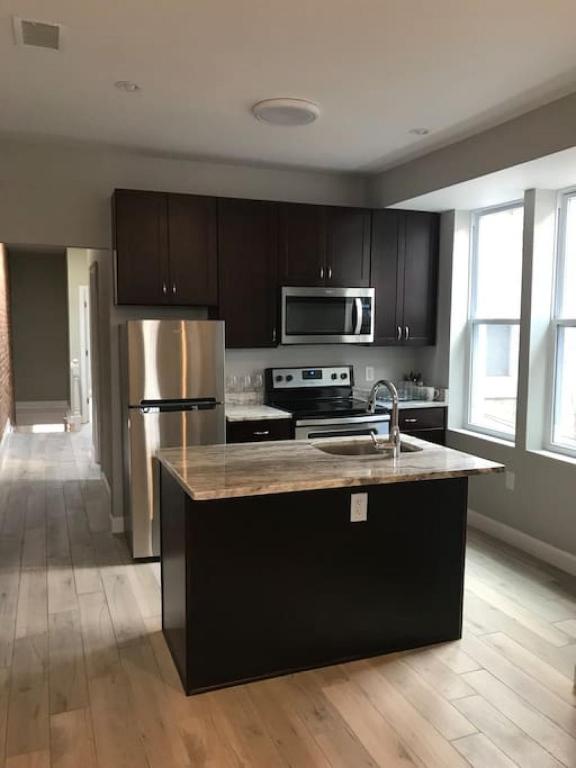 Hotel HOME AWAY HOME - Chic 2 BR Capitol Hill DC, a kitchen with a stainless steel refrigerator and a sink at HOME AWAY HOME - Chic 2 BR Capitol Hill DC in Washington, D.C.