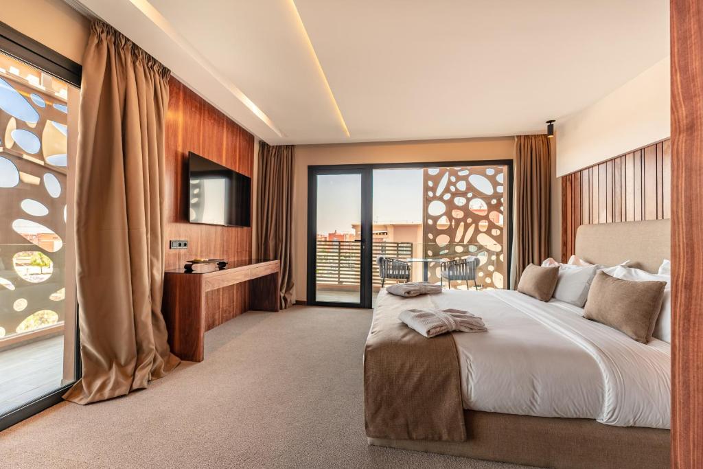 ein Schlafzimmer mit einem großen Bett und einem großen Fenster in der Unterkunft Longue vie Hotels in Marrakesch
