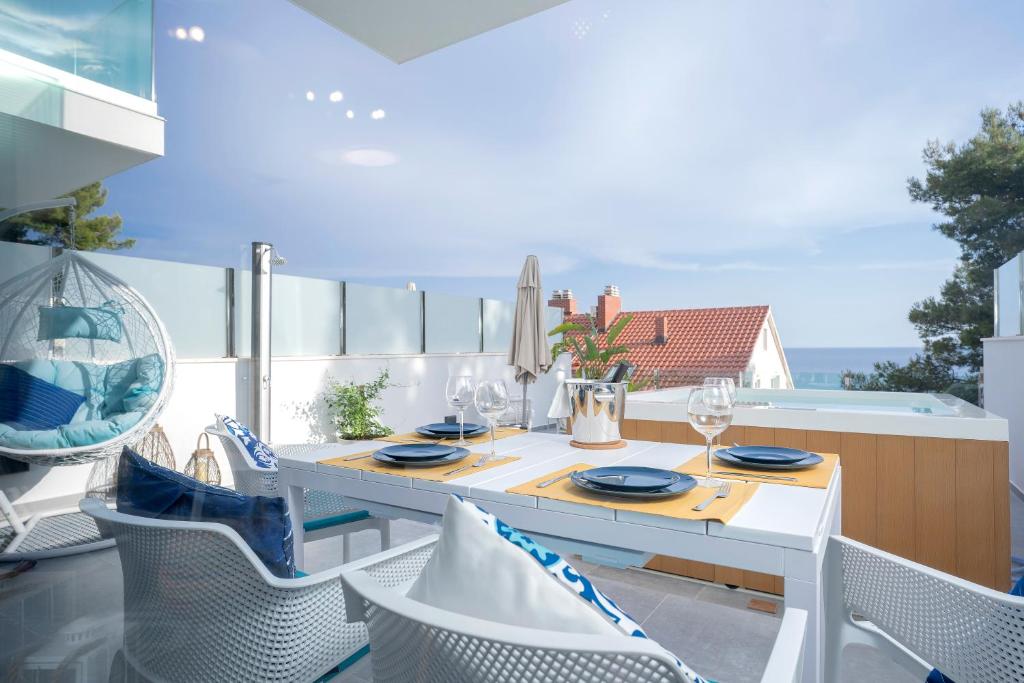 a dining room with a table and chairs on a balcony at NEW! ReLux Hvar - Remote Luxury Homes in Hvar