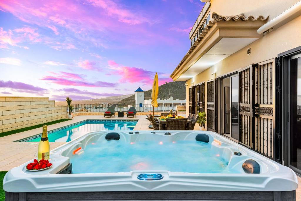 a hot tub on the patio of a house at TORVISCAS SUNSET VILLA & Jacuzzi in Adeje