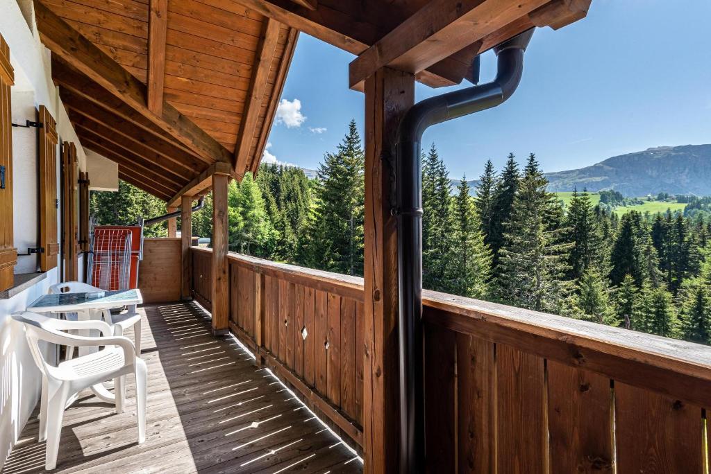a porch of a cabin with a view of the mountains at Ferienparadies Sabina Latsche in Alpe di Siusi