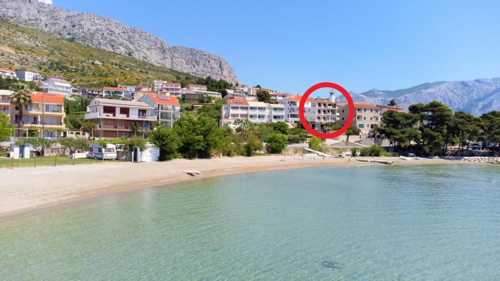 Un cartello rosso pende su una spiaggia di Terra Beach Apartment a Duće