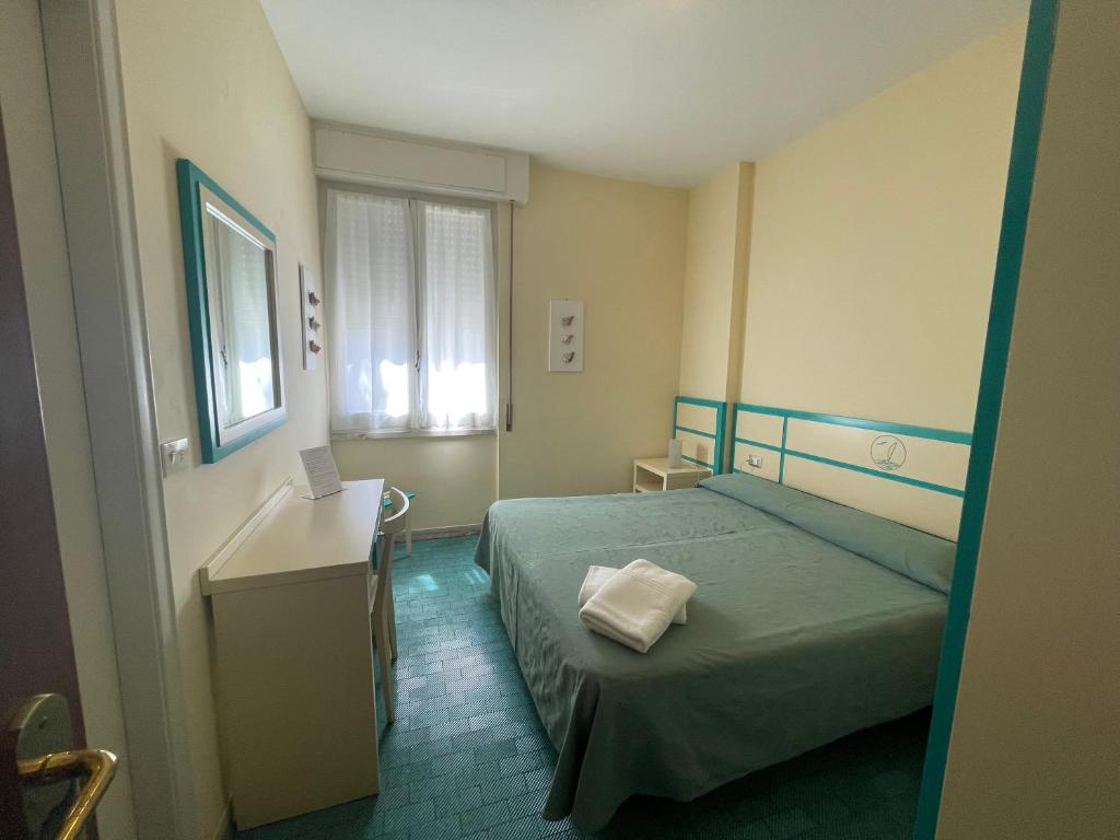 Postel nebo postele na pokoji v ubytování Hotel La Scogliera