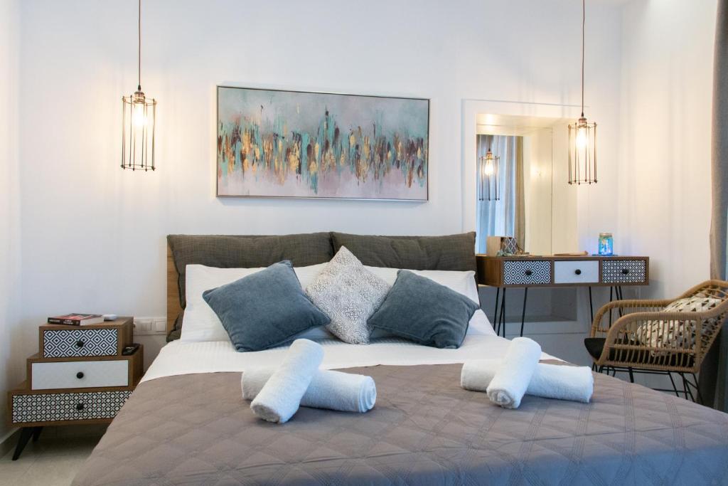 a bedroom with a large bed with two pillows at CAMARA SUITE with Jacuzzzi in Poros