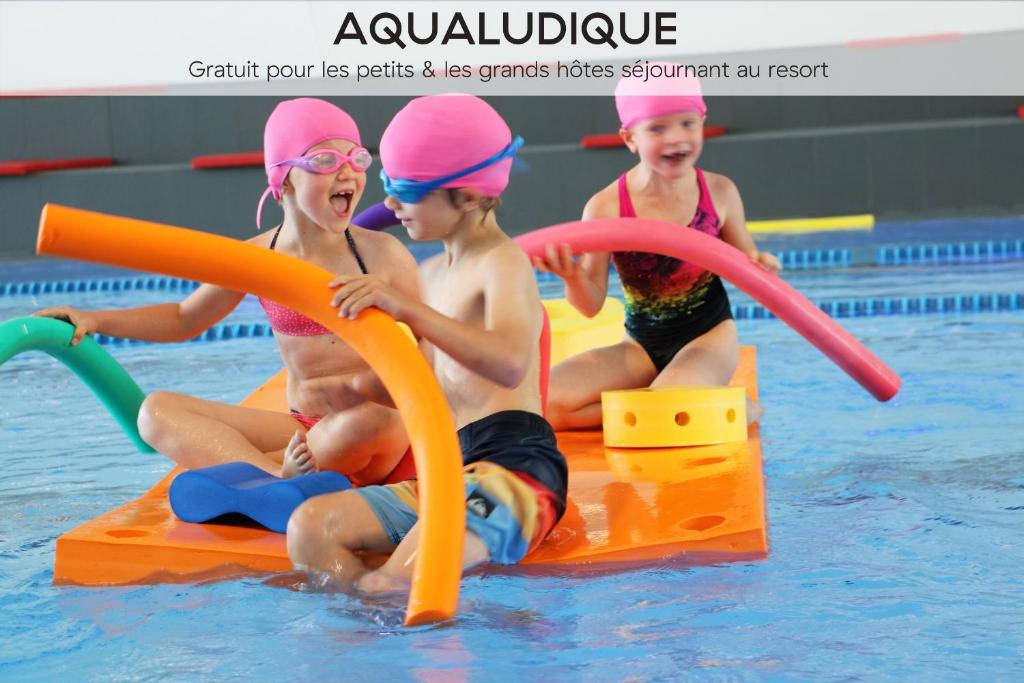 a group of children playing in a swimming pool at Ecrin Blanc Resort Courchevel in Courchevel