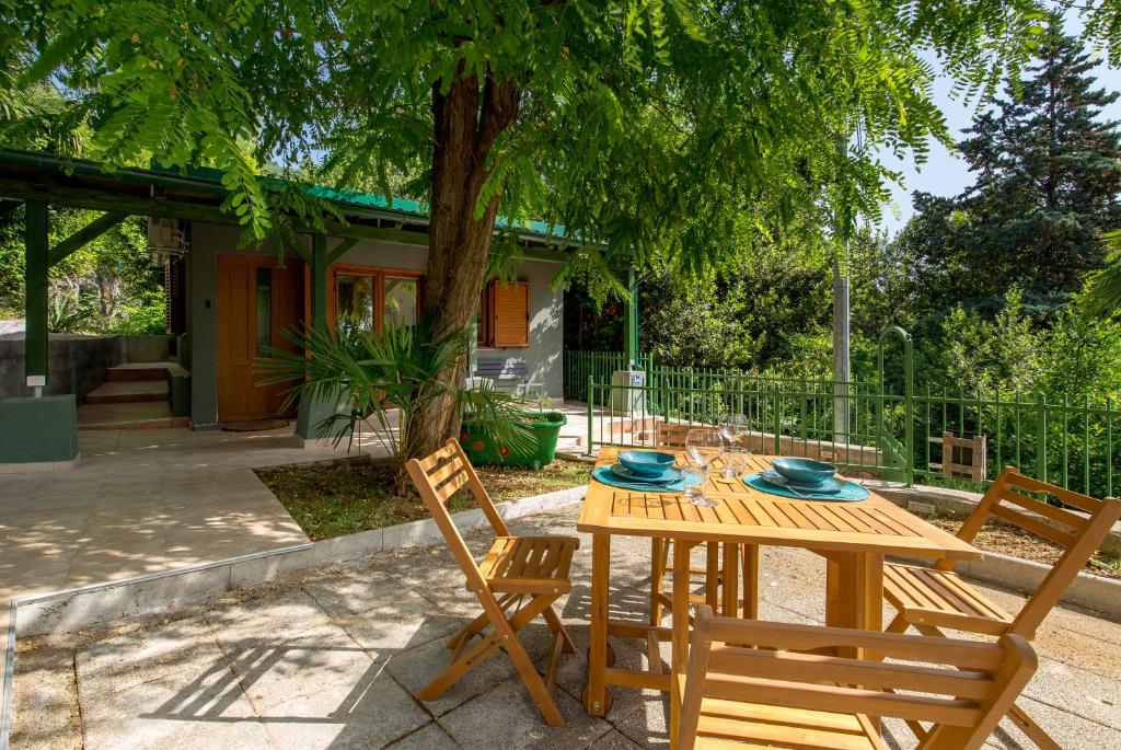 奧帕蒂亞的住宿－Cute & Green，树前的木桌和椅子