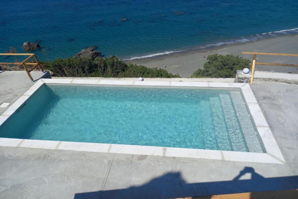 a swimming pool with a view of the ocean at Ocean Bliss Villa in Kerames