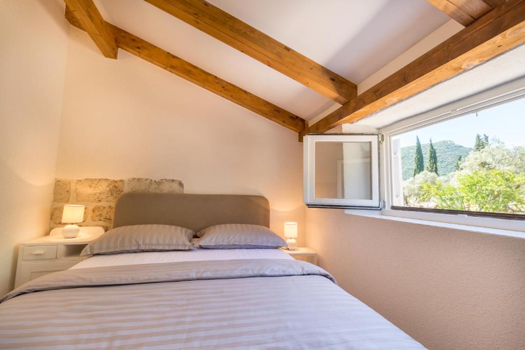 Postel nebo postele na pokoji v ubytování Olive Garden Apartment