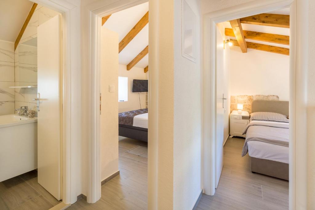 Postel nebo postele na pokoji v ubytování Olive Garden Apartment