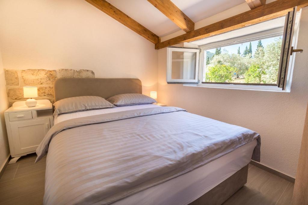 Postel nebo postele na pokoji v ubytování Olive Garden Apartment