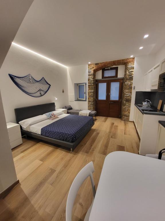 a large bedroom with a bed and a kitchen at Bianca Luna in Manarola