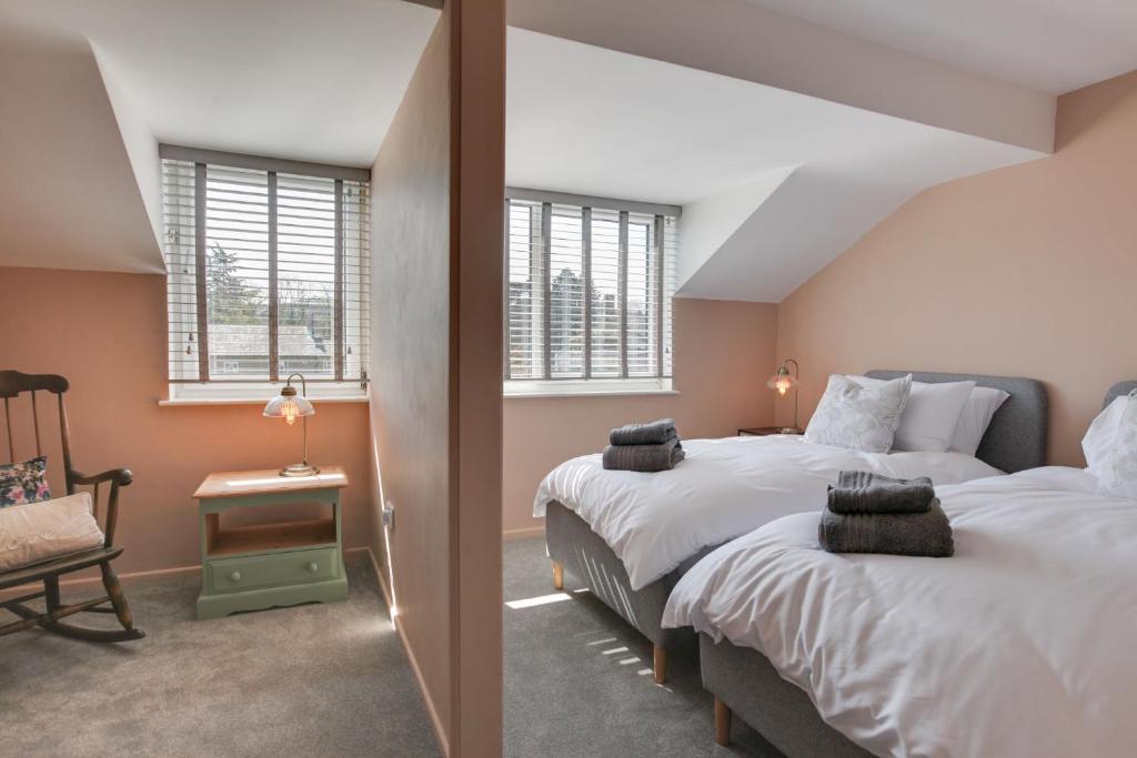 two beds in a room with two windows at Luxury Townhouse - Your Perfect Retreat in Hertford in Hertford
