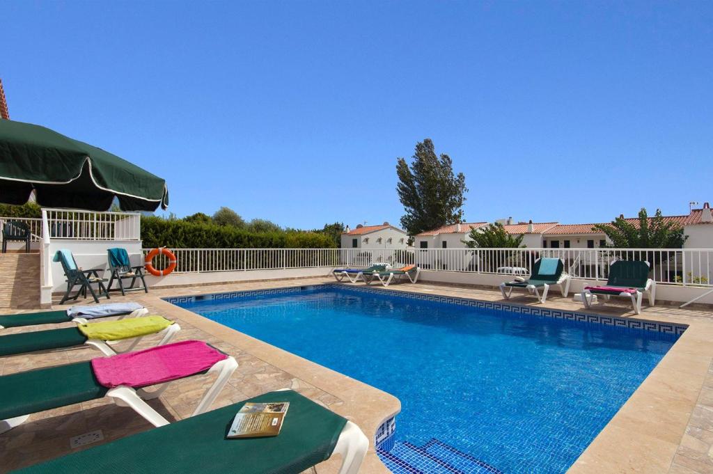 a swimming pool with chaise lounges and chairs around it at Villa Santo Tomas by Villa Plus in Santo Tomás