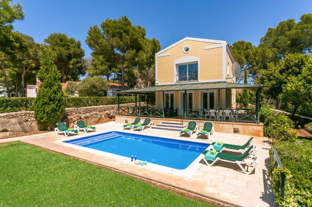 a villa with a swimming pool and a house at Villa Serafina by Villa Plus in Son Parc