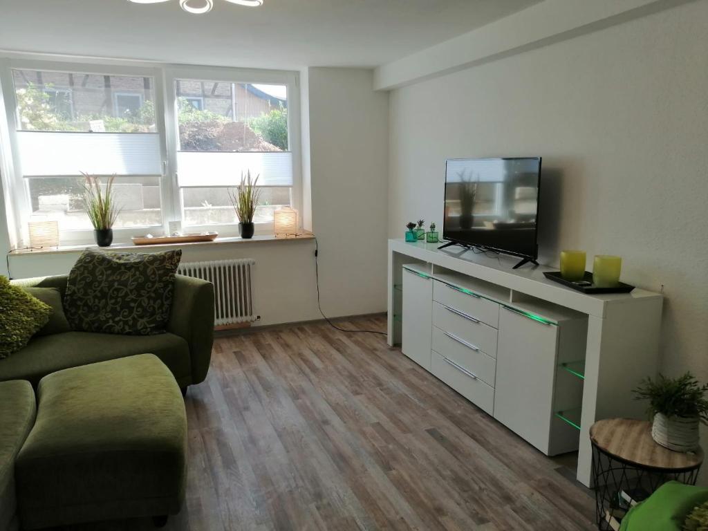 a living room with a couch and a flat screen tv at Ferienwohnung Mohnblume Müddersheim Vettweiß in Vettweiß