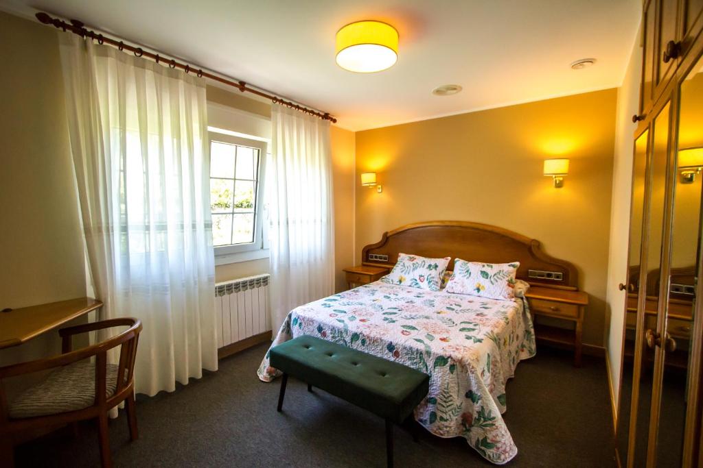 a bedroom with a bed and a window at Hotel San Jorge in Nueva de Llanes