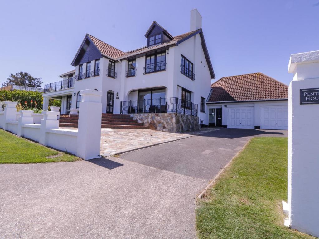 a large white house with a driveway at Pentire House in Deal