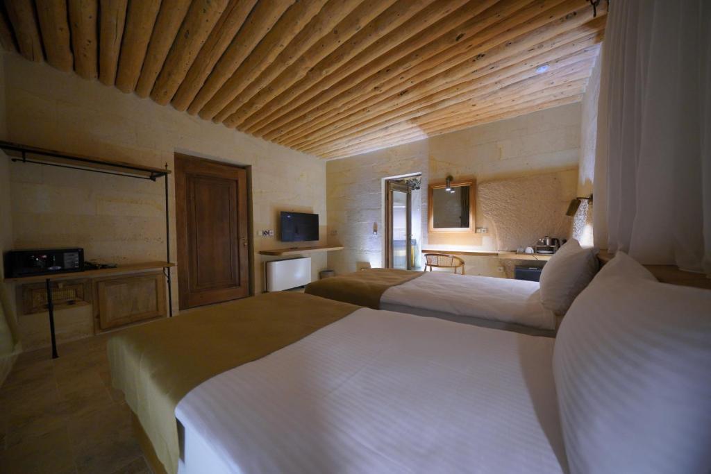 Postel nebo postele na pokoji v ubytování Kappadoks Cave Hotel