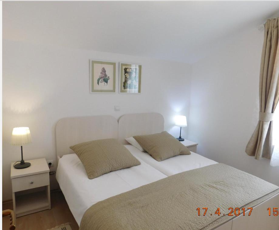 Postel nebo postele na pokoji v ubytování Apartmani ljuta naranča
