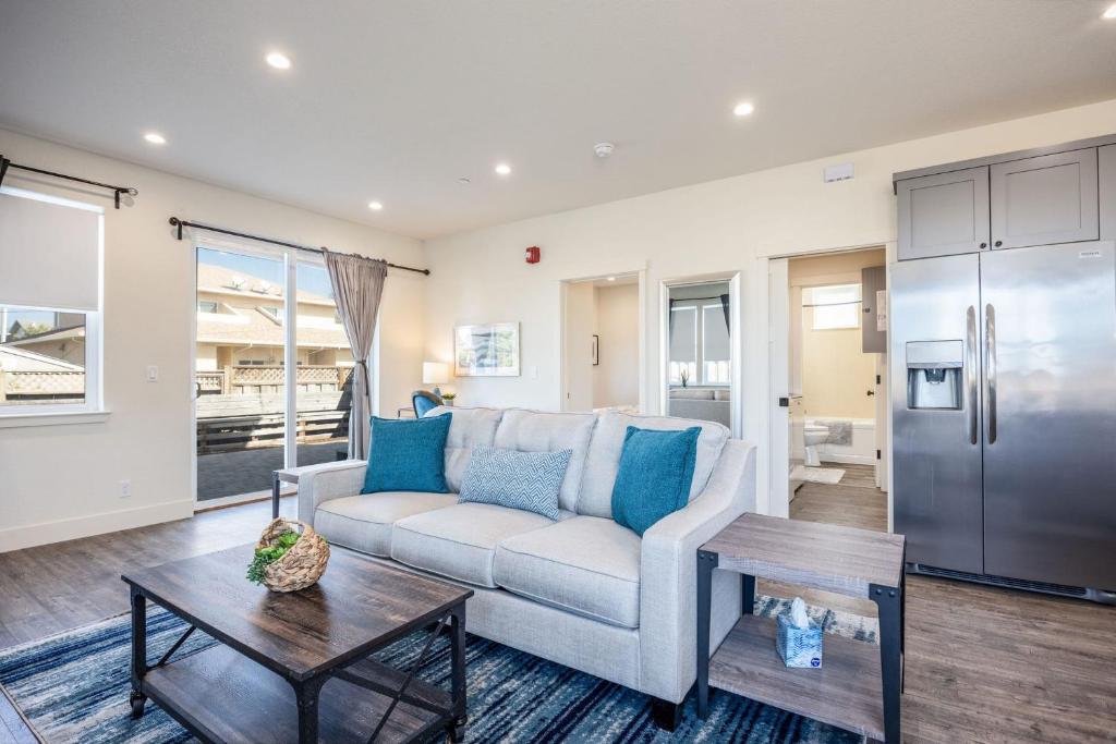 a living room with a couch and a table at Beach Town Home wHot Tub - Walk to Beaches Downtown Activities and more in Half Moon Bay