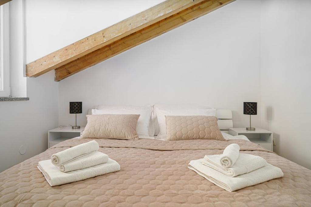 a bedroom with a large bed with two towels on it at Villa Pia in Vodice