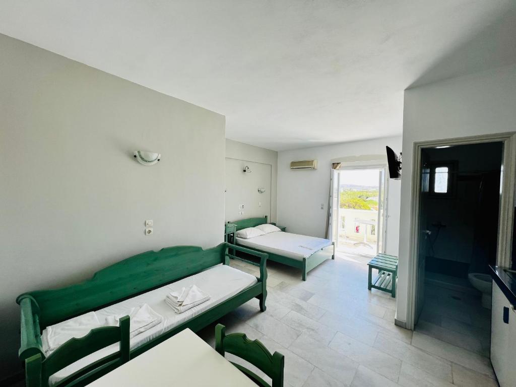 a hospital room with two beds and a window at Korali Garden in Naxos Chora