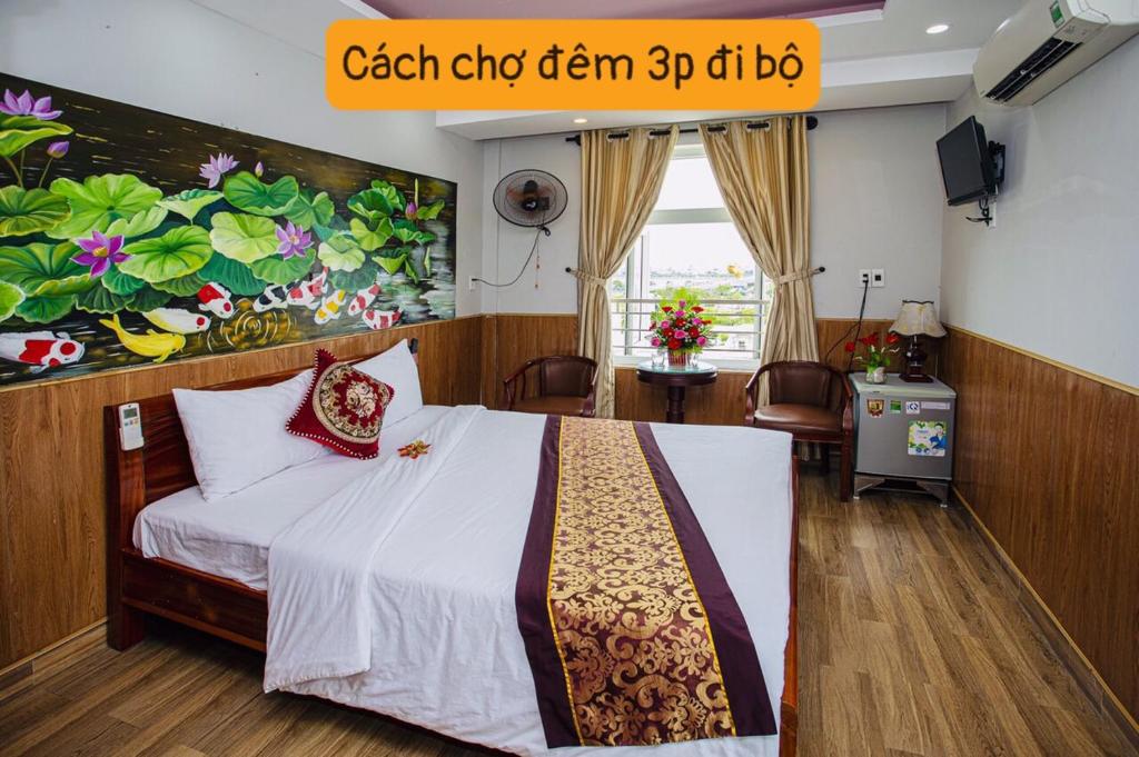 a bedroom with a bed and a painting on the wall at Cong Thuong Hotel in Da Nang