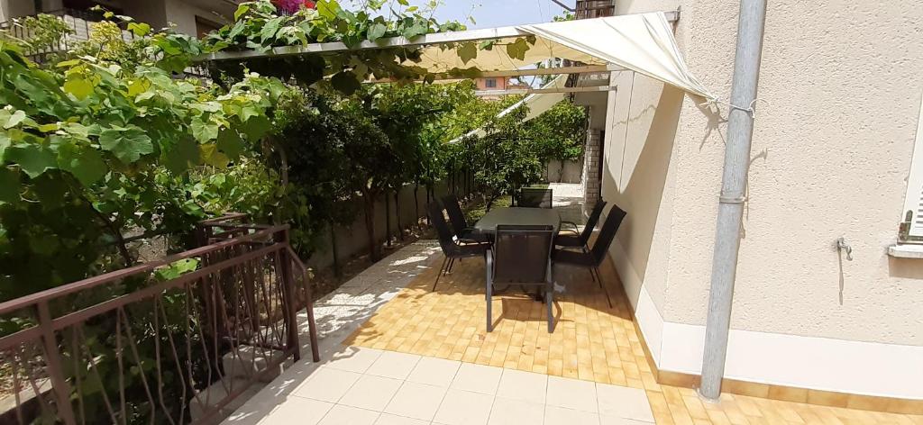 an outdoor patio with a table and an umbrella at Apartment LAGUNA 37 in Izola