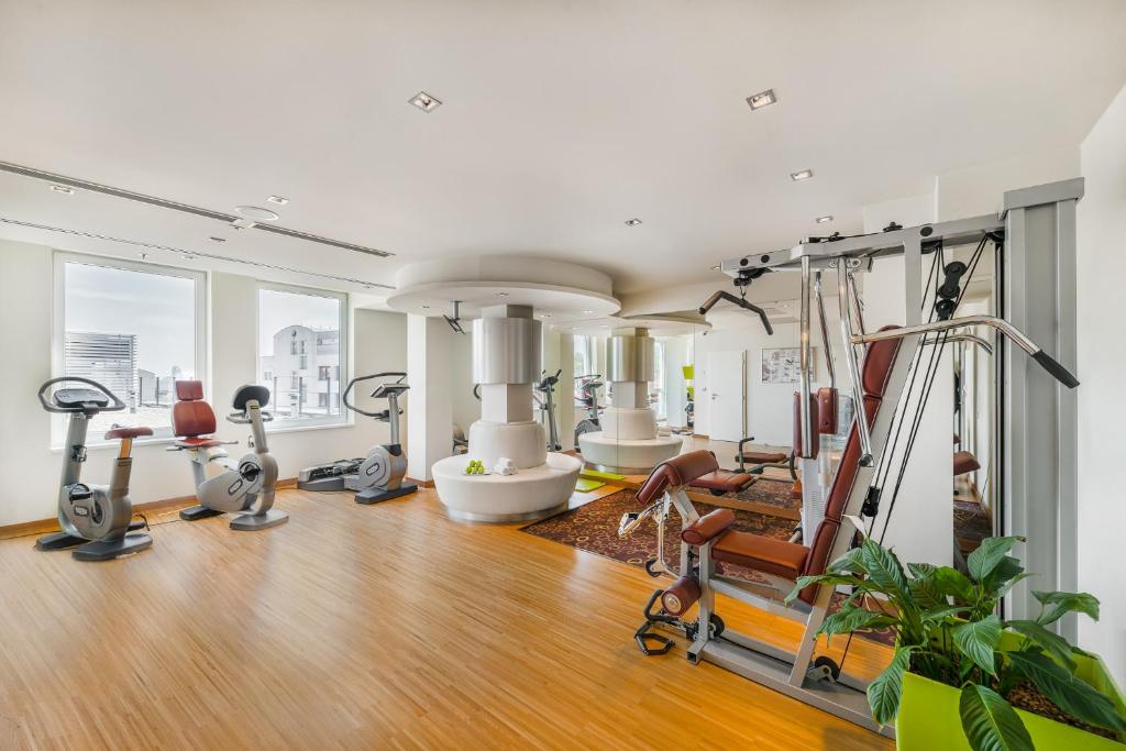 a gym with treadmills and exercise equipment in a room at Clarion Congress Hotel Bratislava in Bratislava