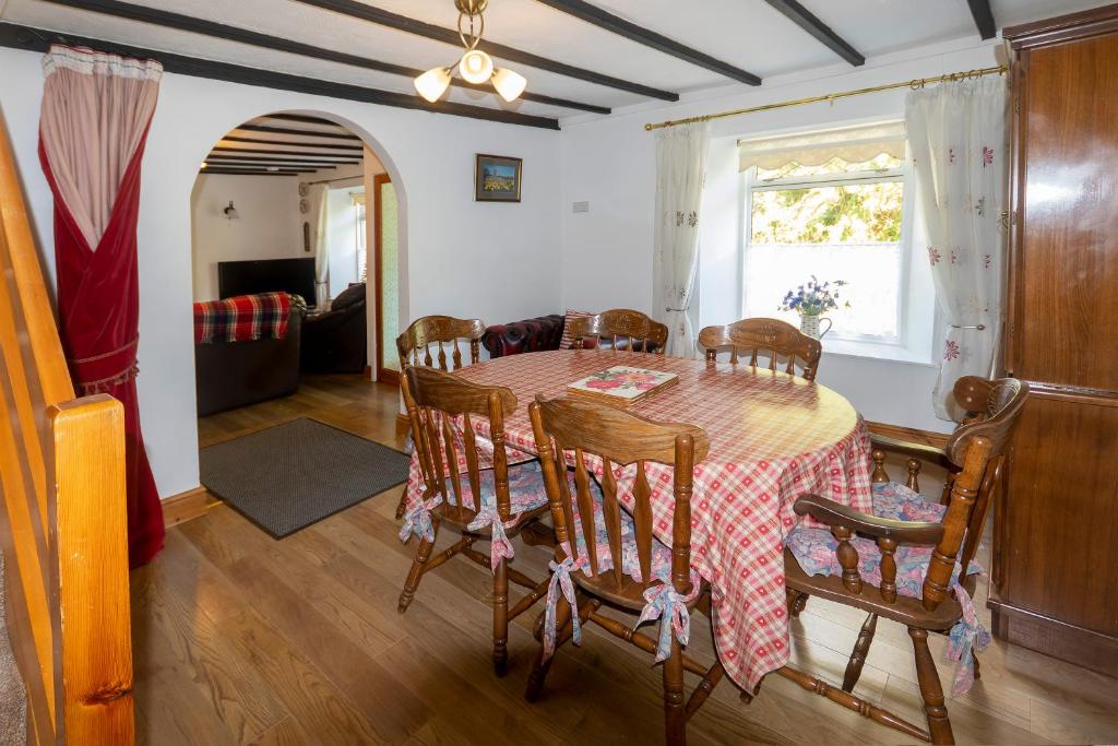 a dining room with a table and chairs at Thorn cottage in Fishguard