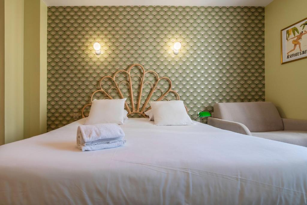 Postel nebo postele na pokoji v ubytování Hôtel Cosmopolitain