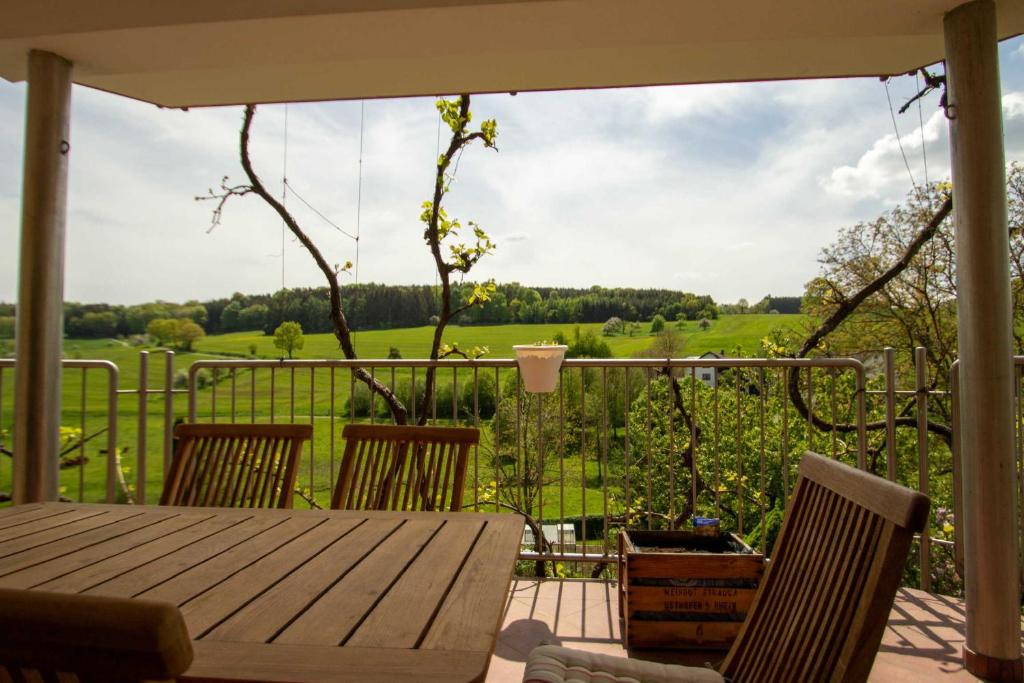 a patio with a table and chairs and a view at Am Wiesental in Steinbuch