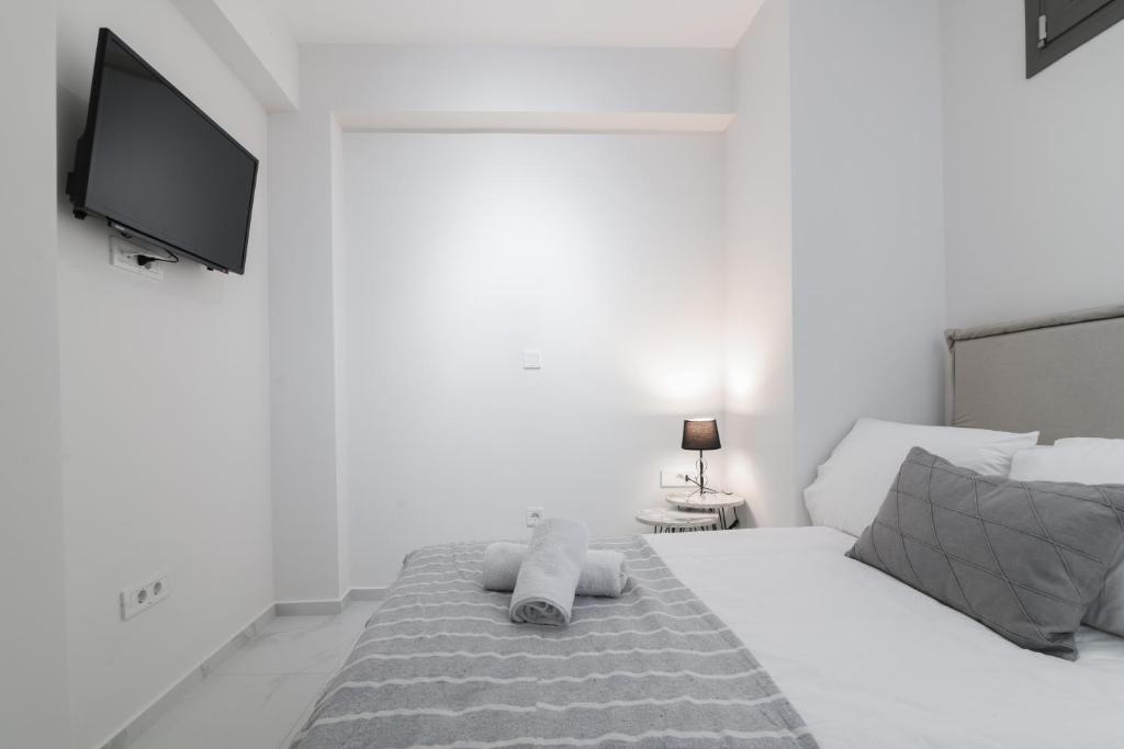 Postel nebo postele na pokoji v ubytování Centro Studios & Apartments
