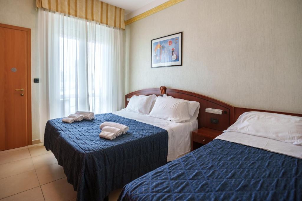 Postel nebo postele na pokoji v ubytování Hotel Rex Rimini