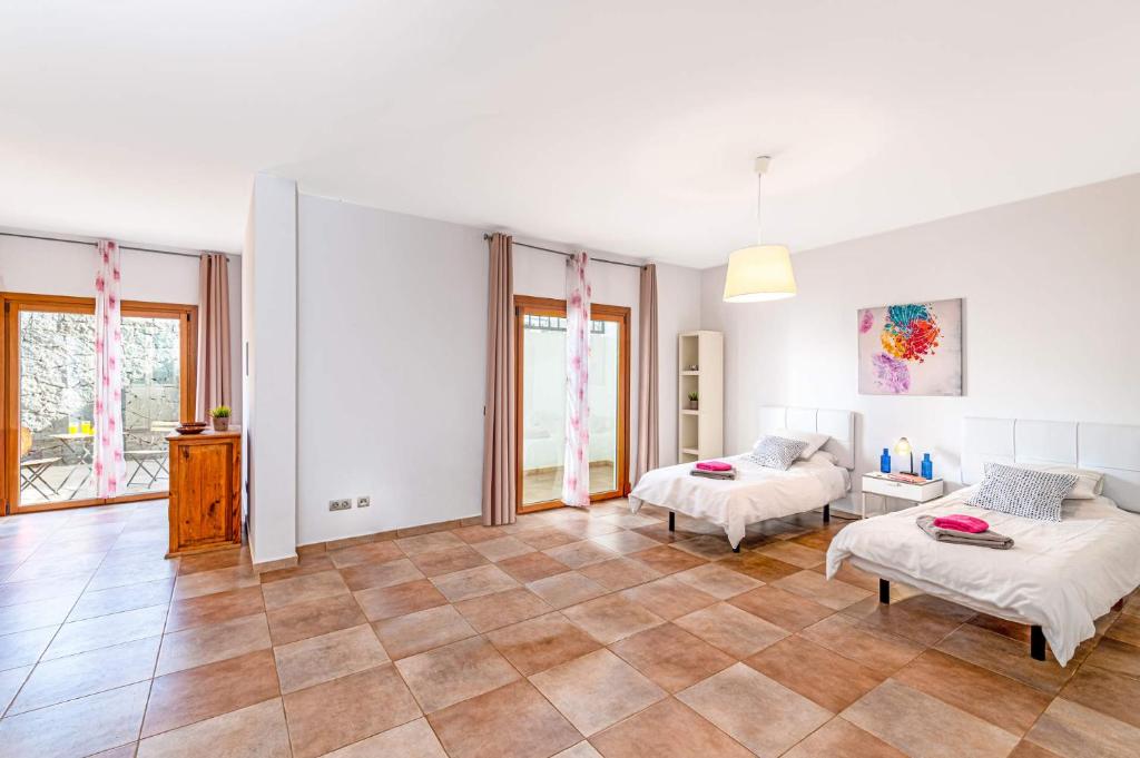 A bed or beds in a room at Villa Inma Calero by Villa Plus
