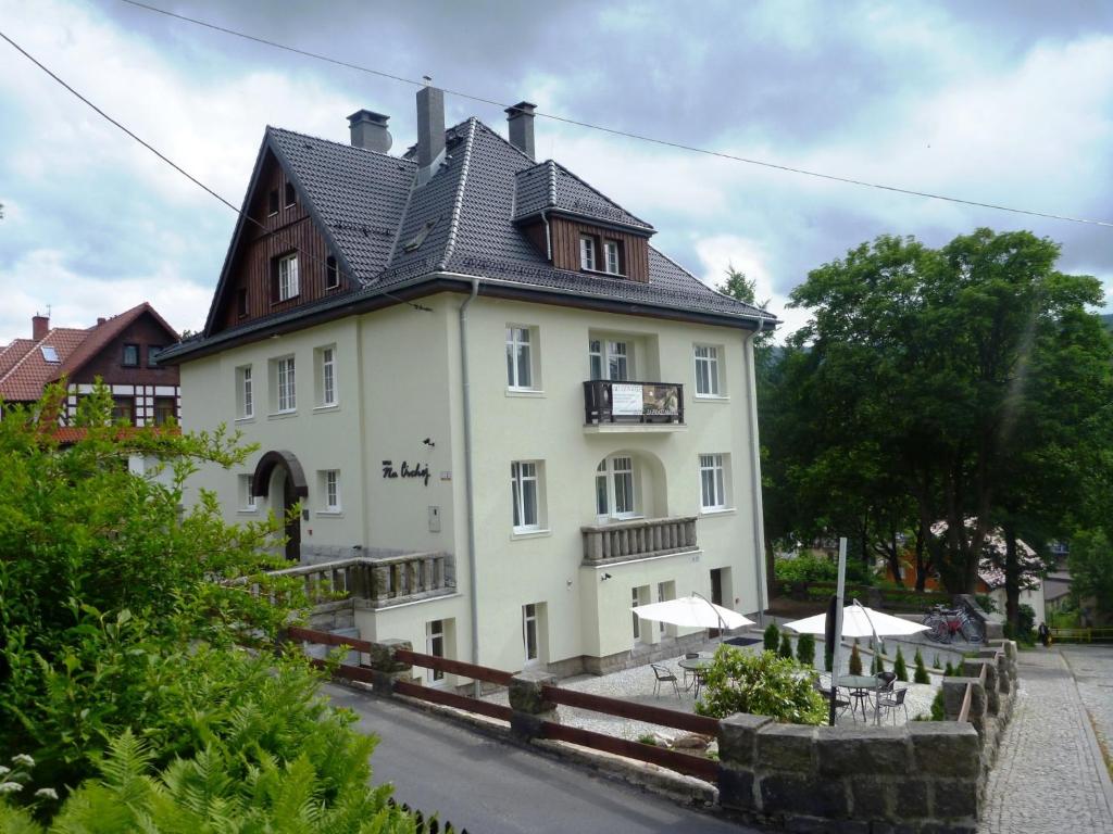 a large white building with a black roof at Willa Na Cichej in Szklarska Poręba