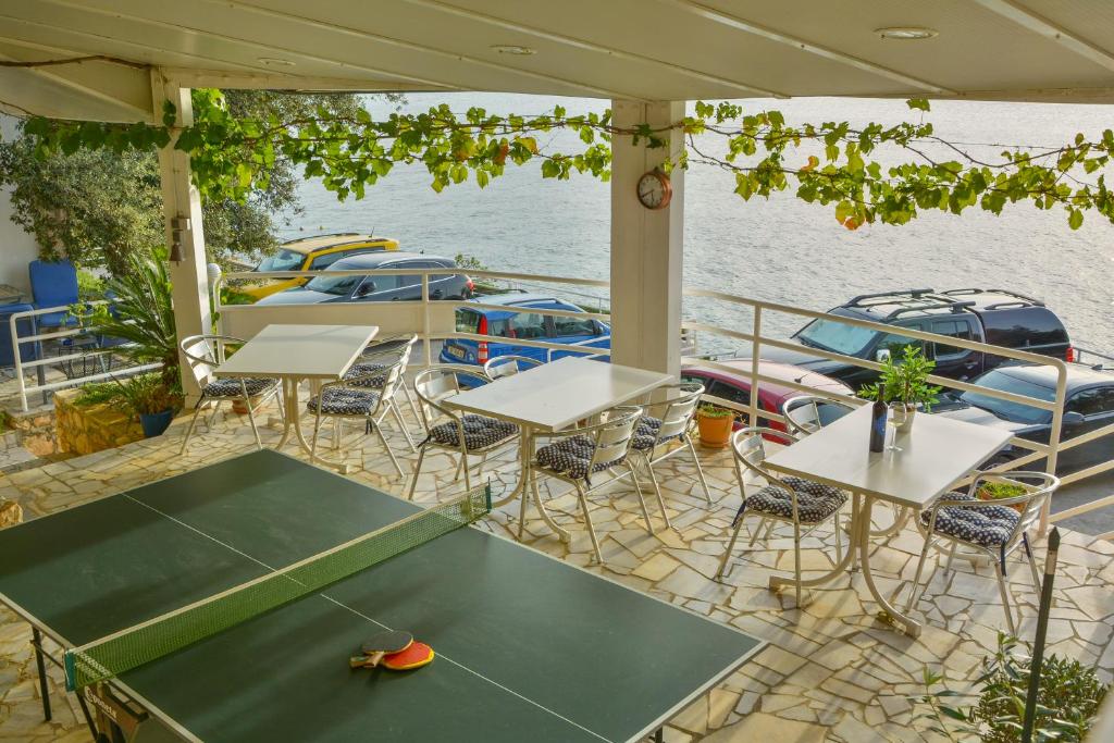 a table and chairs on the deck of a boat at Apartments Miki in Donja Klada