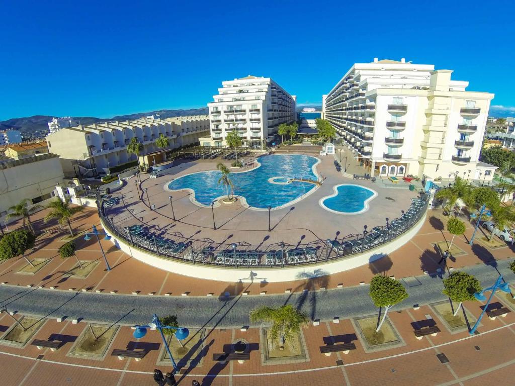 an aerial view of a pool in a city with buildings at Peñiscola Plaza Suites in Peniscola
