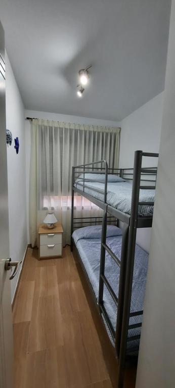 a bedroom with two bunk beds and a window at Apartamento Marina en Moraira in Moraira