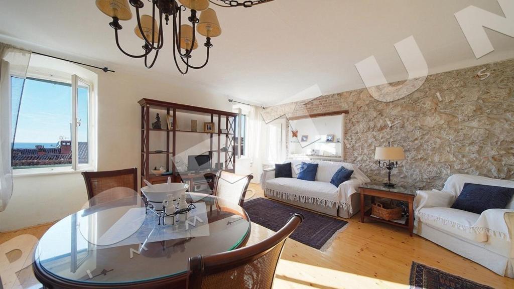 a living room with a glass table and a couch at Villa Augusta Ferri in Rovinj