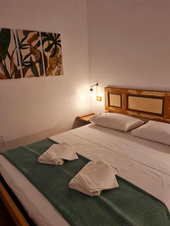 a bedroom with a bed with two towels on it at Eva Luna in Ostuni