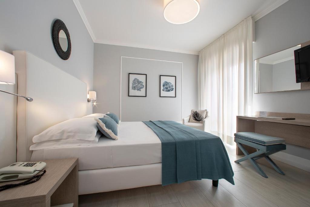 Postel nebo postele na pokoji v ubytování Hotel Imperial Palace
