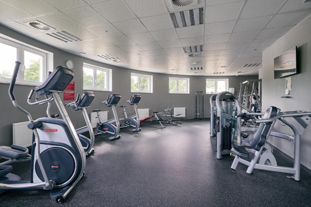 a gym with several treadmills and cardio machines at Apartman Residence Moser 1504 in Karlovy Vary
