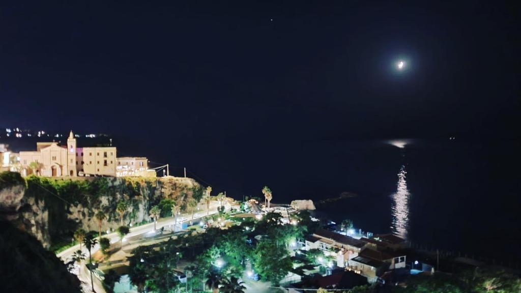 a view of a city at night with a full moon at Nereide in Tropea