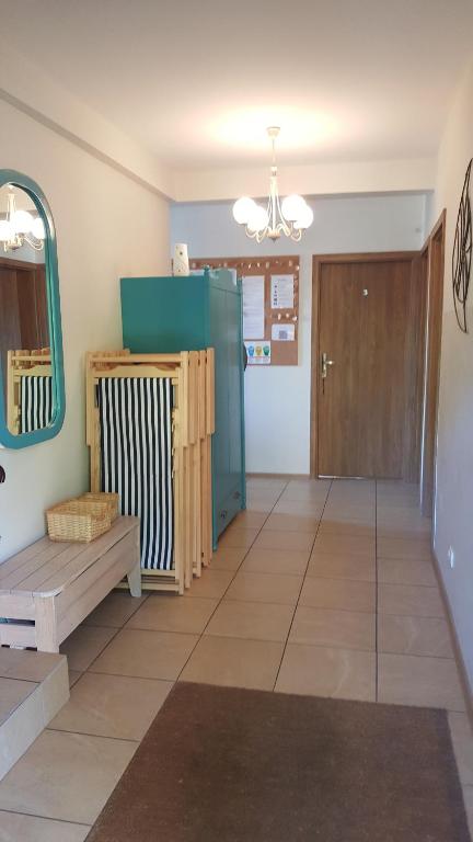 a living room with a bench and a mirror at Pestka in Jastarnia