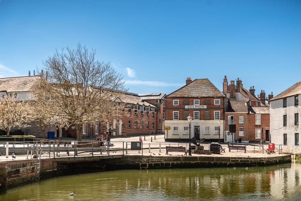 a bridge over a river in a town with buildings at 3, The Dolphin, 49 Quay Street - Stunning apartment - Quintessential - Quay views - Sleeps 2-4 people in Newport